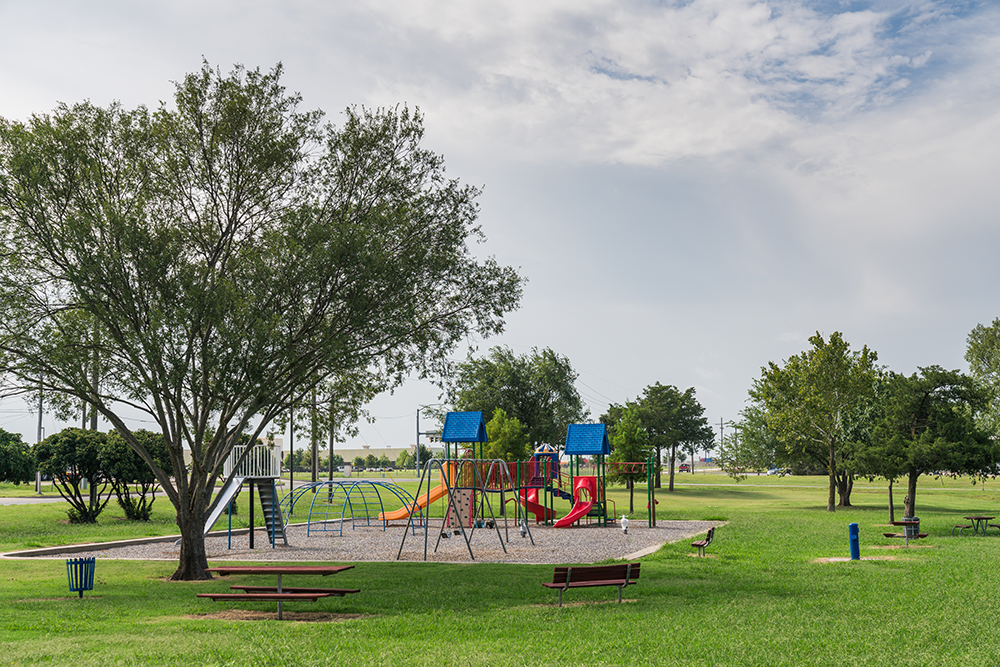 Wide-range view of playground surrounded by green space.
