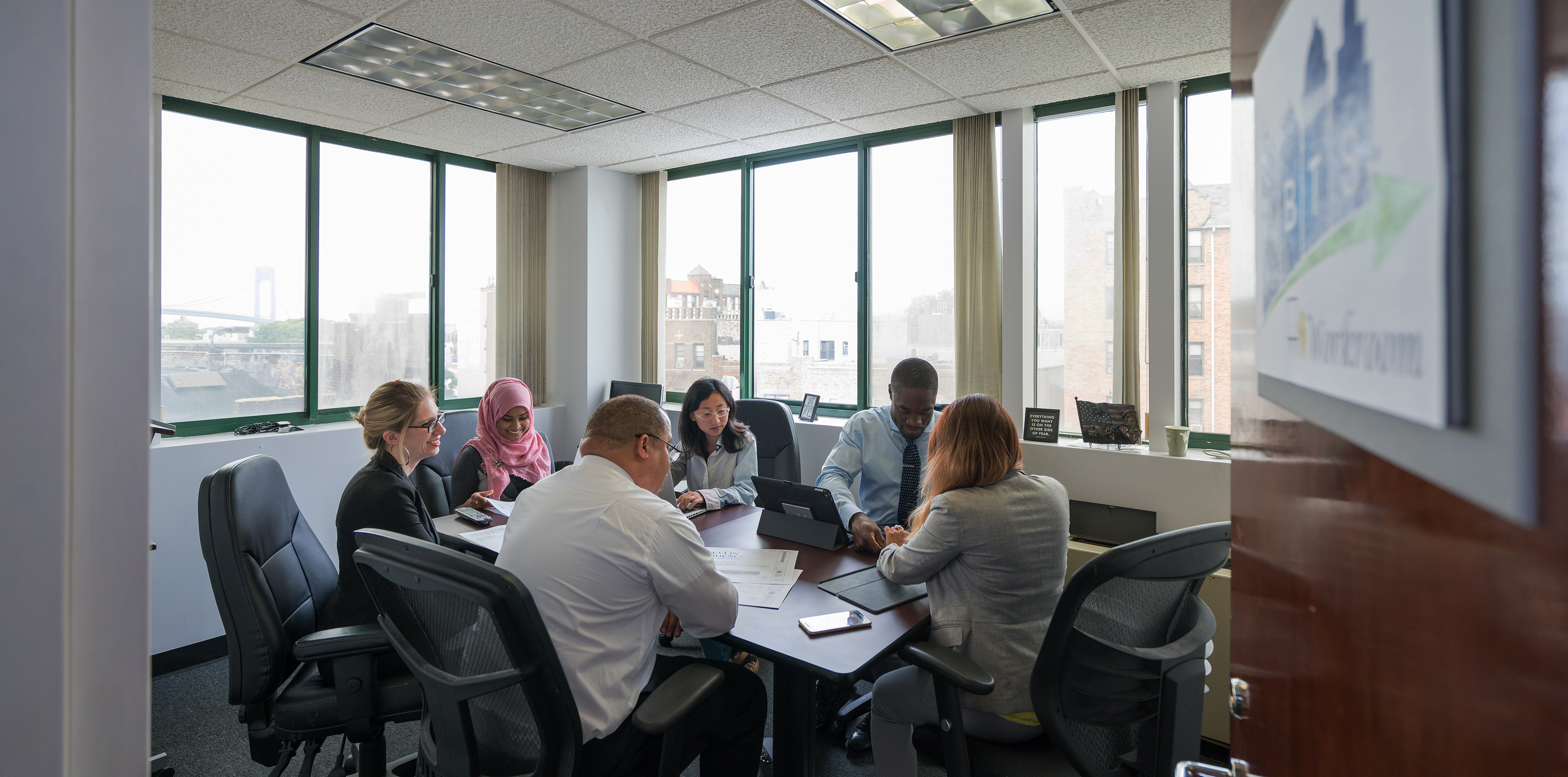 IBTS employees working in a conference room in our Brooklyn, NY office.