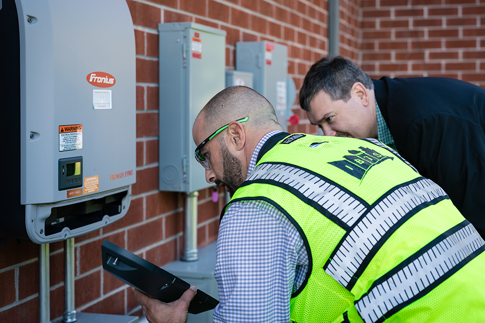 IBTS employee inspects external building equipment.